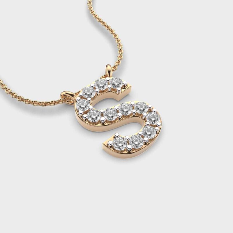 Angled close-up of a 14K gold letter S pendant set with round lab grown diamonds.