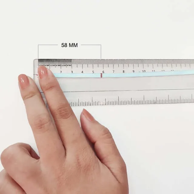Close-up of hand measuring ring size using a ring sizer tool