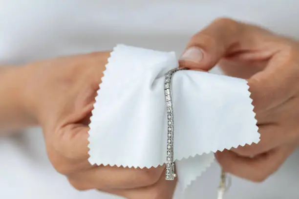 Cleaning a diamond bracelet with soft brush and soapy water