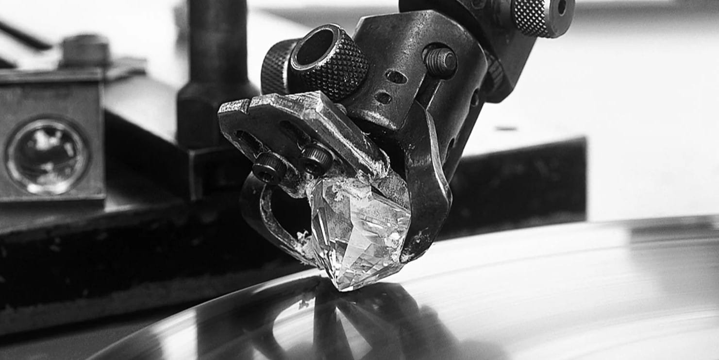 diamond cutting 1 Diamond cutting process showing precision tools shaping rough diamond into polished gemstone