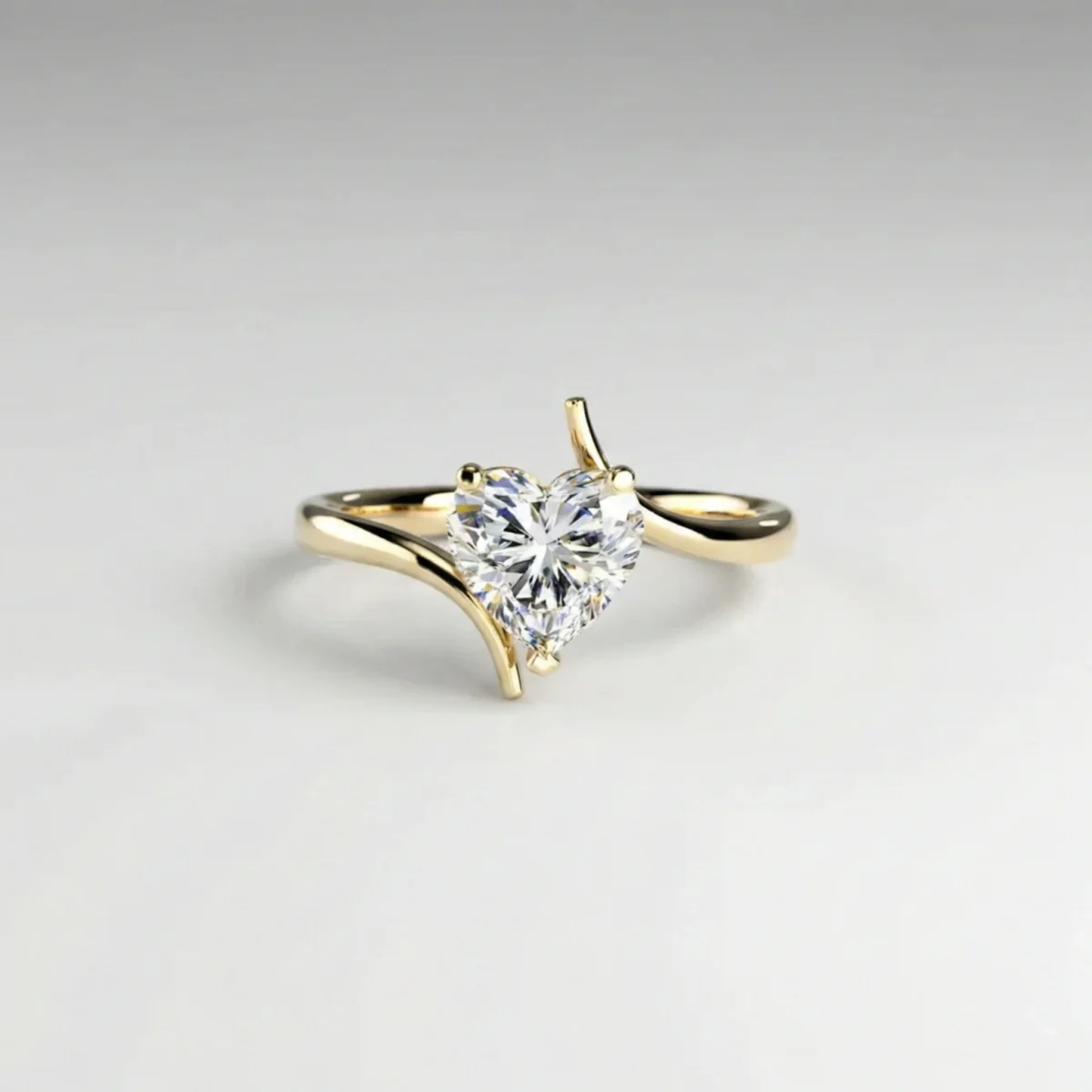 1.0 ct heart lab grown diamond asymmetric solitaire engagement ring in yellow gold with raised four-prong setting