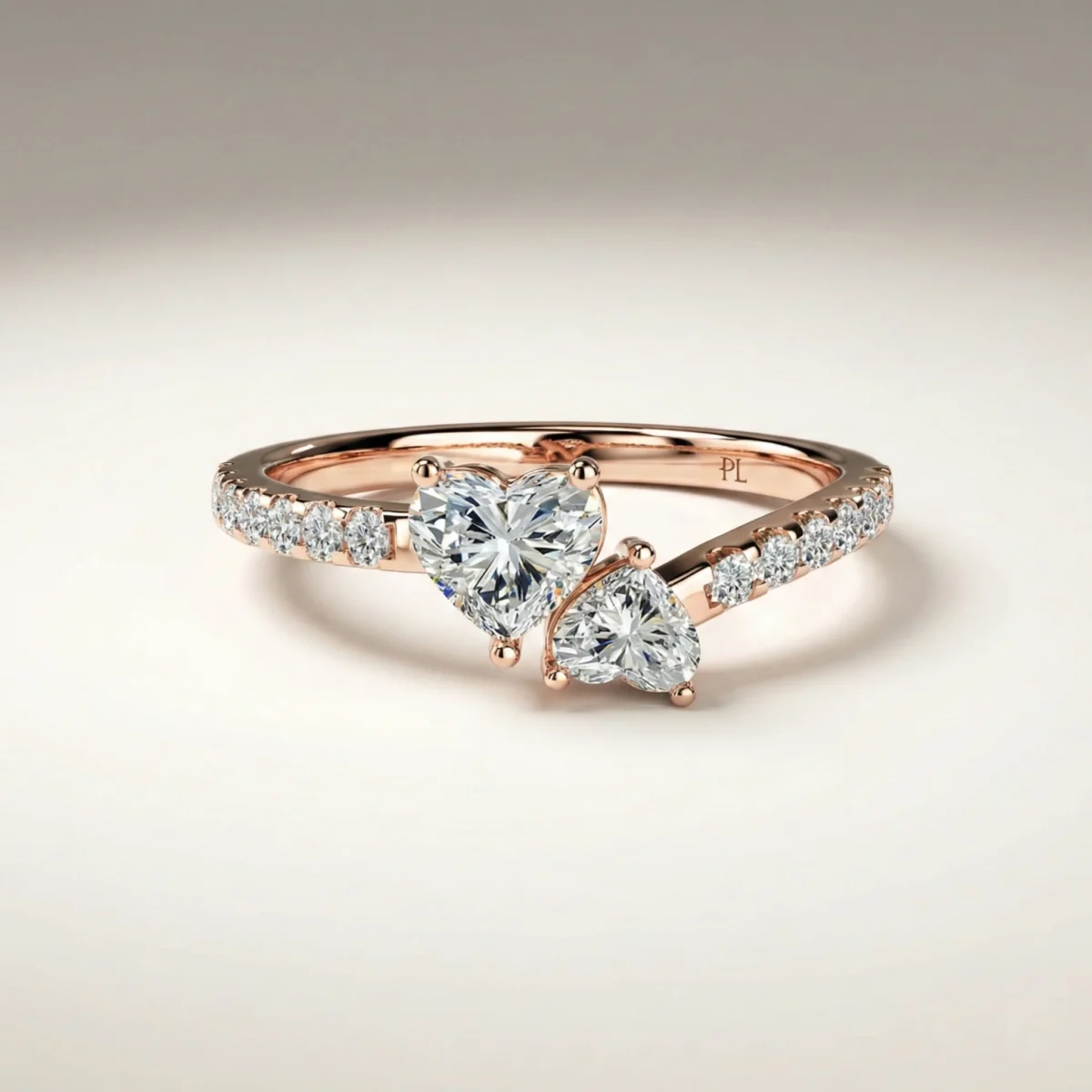 Heart-shaped dual-stone asymmetric bypass lab grown diamond engagement ring with approximately 0.75 ct total diamonds and pavé shoulders in rose gold.