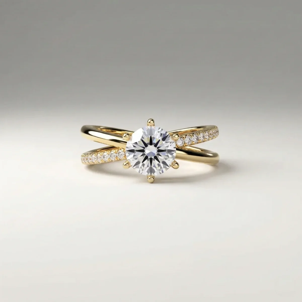 1.0 carat round brilliant lab grown diamond crossover pavé engagement ring in yellow gold with six-prong solitaire setting.