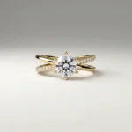 1.0 carat round brilliant lab grown diamond crossover pavé engagement ring in yellow gold with six-prong solitaire setting.