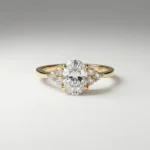 0.75 carat oval lab grown diamond engagement ring with side cluster diamonds in yellow gold