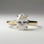 Oval four-prong solitaire 1 carat lab grown diamond engagement ring in yellow gold with slim polished band.