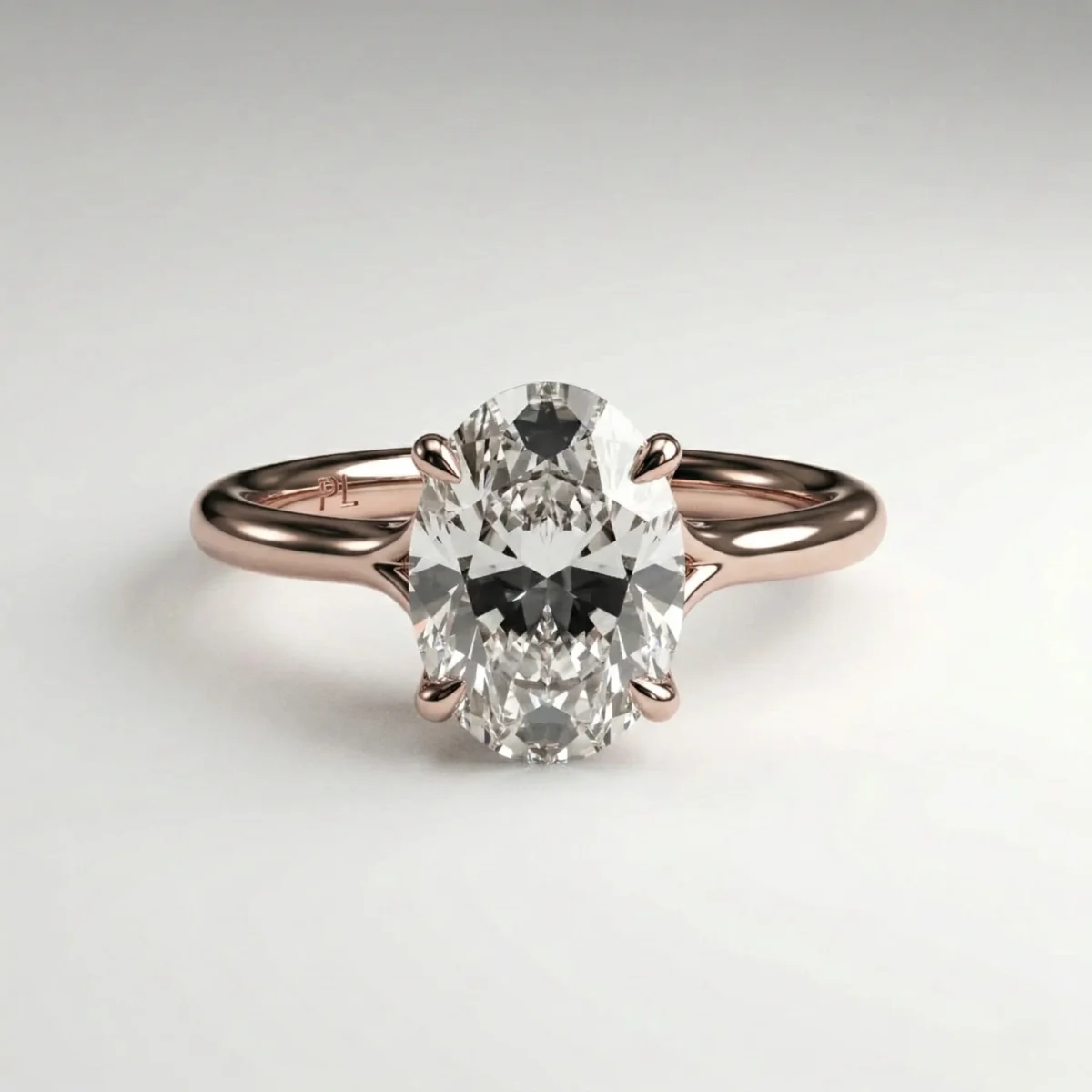 1 carat oval lab grown diamond cathedral solitaire engagement ring in rose gold with four claw prongs and slim band.