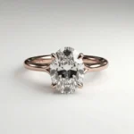 1 carat oval lab grown diamond cathedral solitaire engagement ring in rose gold with four claw prongs and slim band.