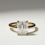 1.0 ct emerald cut lab grown diamond hidden halo engagement ring with pavé gallery in yellow gold