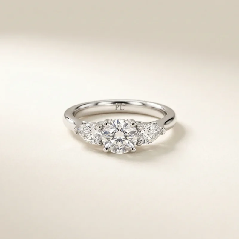 1 carat round lab grown diamond three stone engagement ring with pear side diamonds in white gold